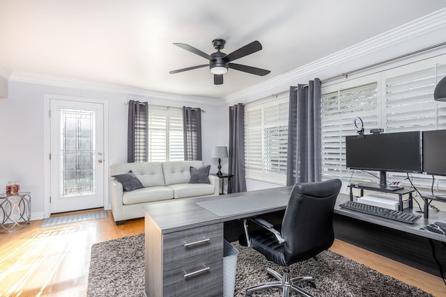 office space featuring baseboards, wood finished floors, a ceiling fan, and ornamental molding