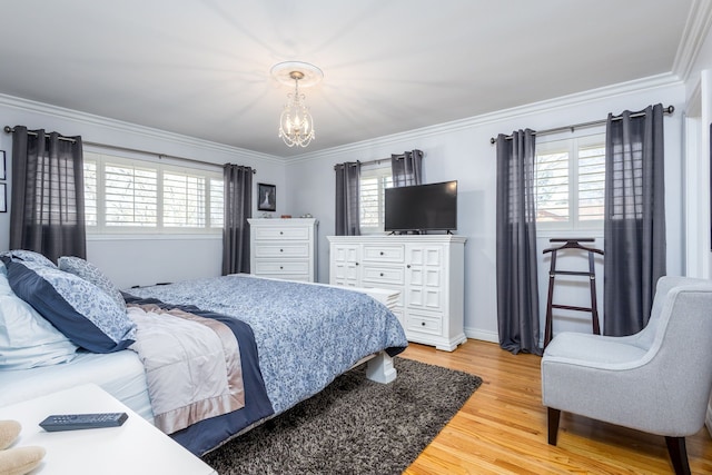 bedroom with a chandelier, multiple windows, and crown molding