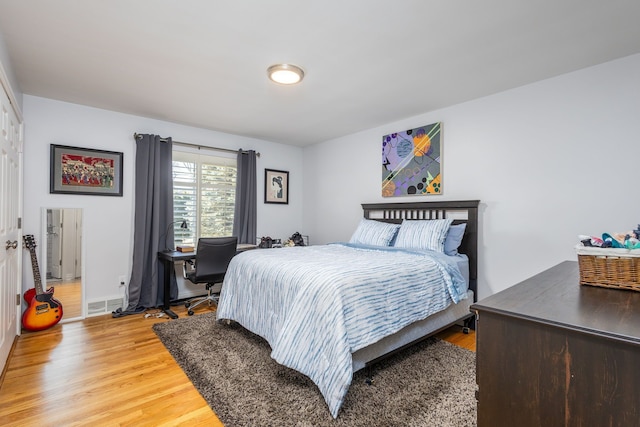 bedroom with visible vents and light wood finished floors