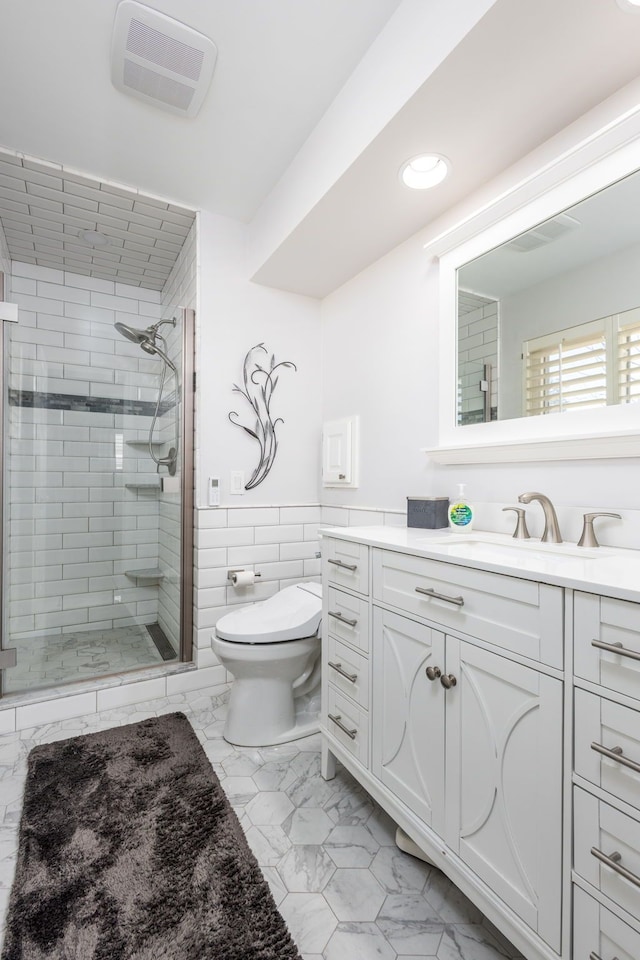 bathroom featuring visible vents, toilet, a stall shower, marble finish floor, and vanity