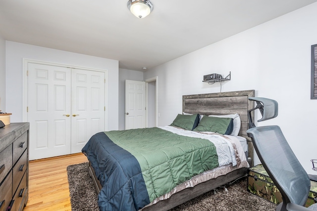 bedroom with light wood-style flooring and a closet