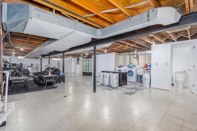 unfinished below grade area with tile patterned floors and washing machine and dryer