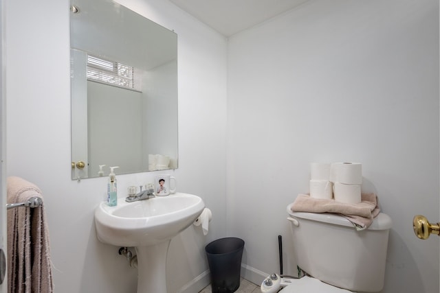 half bath with toilet and baseboards