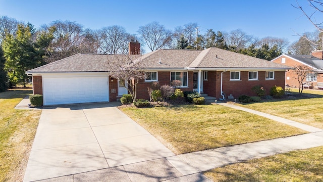 ranch-style home with concrete driveway, an attached garage, a front yard, brick siding, and a chimney