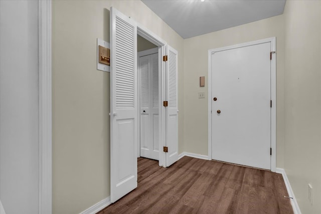 foyer entrance featuring wood finished floors and baseboards