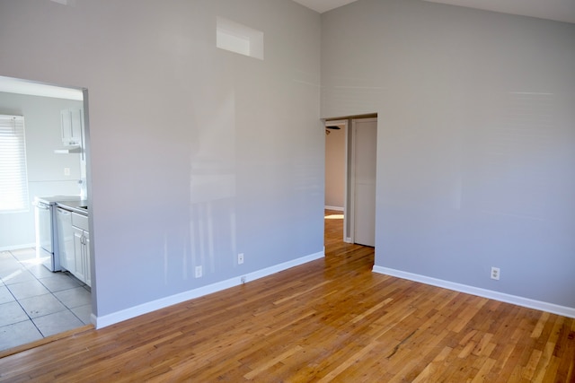 empty room featuring baseboards and light wood-style floors