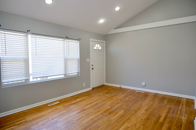 spare room featuring visible vents, baseboards, vaulted ceiling, recessed lighting, and light wood-style flooring