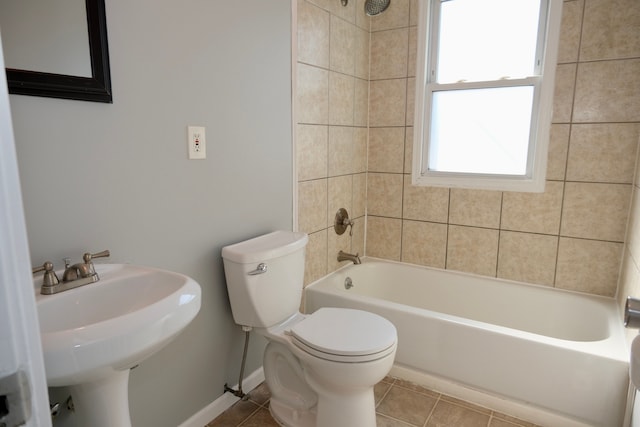 full bathroom with tile patterned flooring, baseboards, toilet, shower / bathtub combination, and a sink