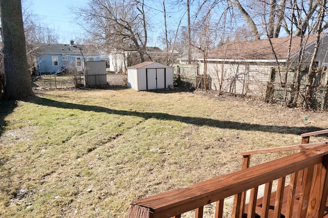 view of yard with a fenced backyard, an outdoor structure, and a shed