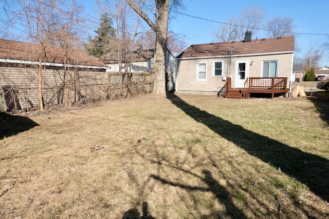 view of yard with a wooden deck and fence