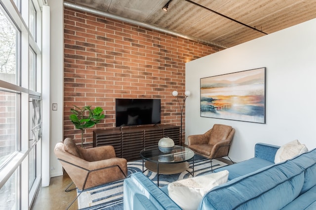 living room with finished concrete floors and wooden ceiling