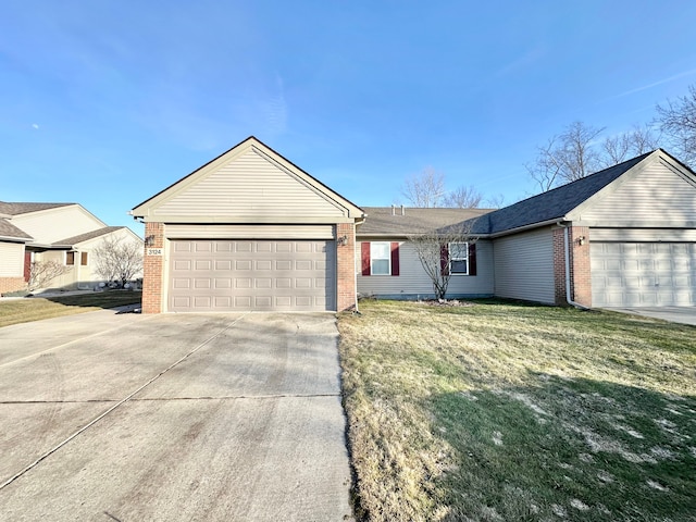 ranch-style home featuring brick siding, an attached garage, driveway, and a front lawn