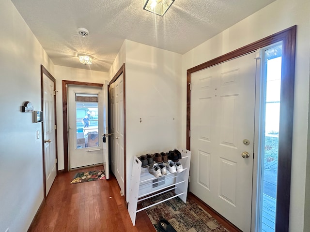 entrance foyer featuring dark wood-type flooring and a textured ceiling