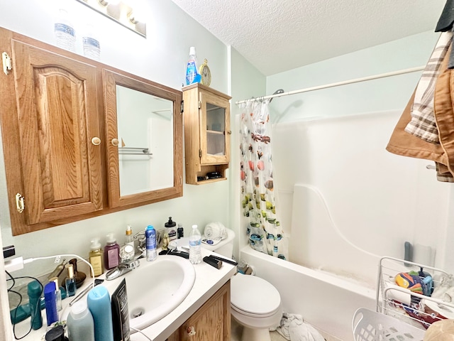 bathroom featuring toilet, a textured ceiling, vanity, and shower / bathtub combination with curtain