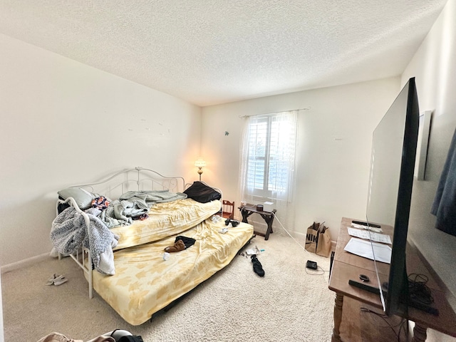 bedroom featuring baseboards, a textured ceiling, and carpet flooring