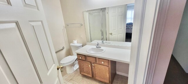 full bath with toilet, vanity, and tile patterned flooring