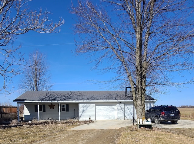 view of front of home featuring covered porch, driveway, a garage, and roof with shingles