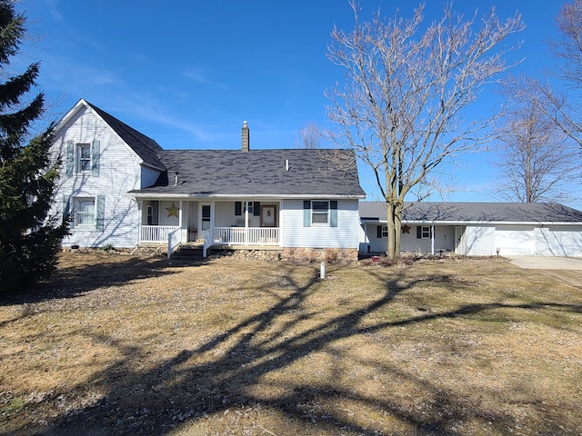 rear view of property featuring a porch, roof with shingles, a chimney, a garage, and driveway