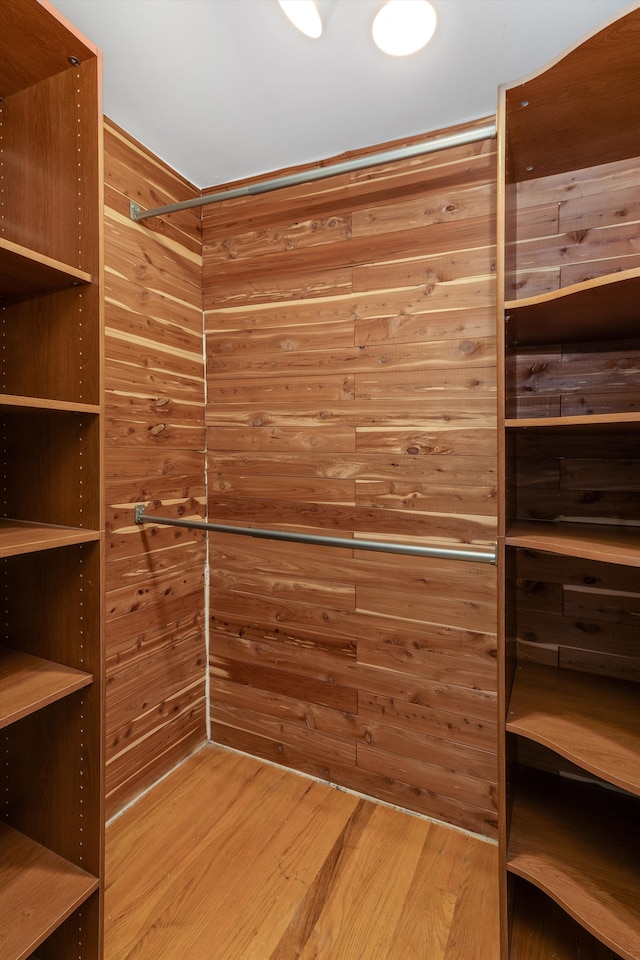 walk in closet featuring wood finished floors