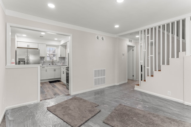 interior space featuring stairway, recessed lighting, visible vents, and baseboards