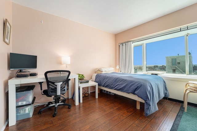 bedroom featuring baseboards and wood-type flooring