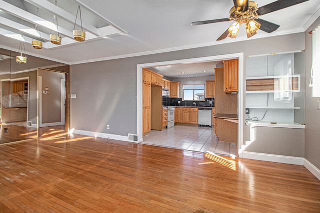 unfurnished living room with visible vents, light wood-type flooring, a ceiling fan, and ornamental molding