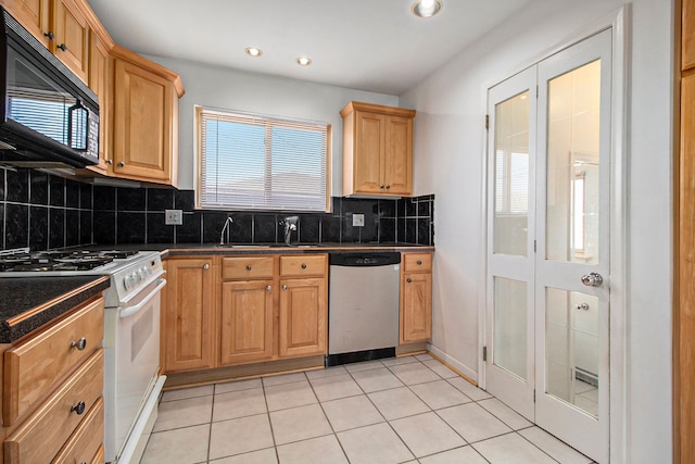 kitchen featuring a sink, white gas range oven, black microwave, stainless steel dishwasher, and dark countertops