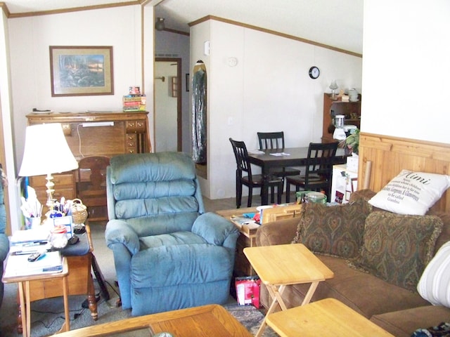 living room featuring lofted ceiling, a wainscoted wall, and ornamental molding