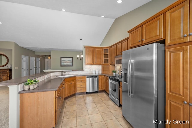 kitchen with light tile patterned floors, a peninsula, stainless steel appliances, glass insert cabinets, and brown cabinets