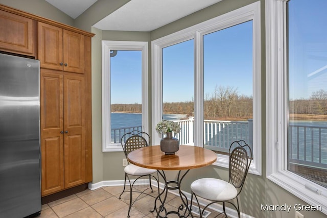 dining area with light tile patterned floors and baseboards