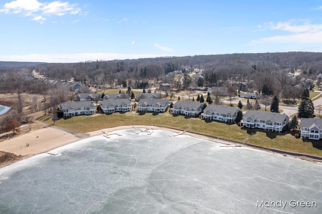 bird's eye view featuring a forest view and a residential view