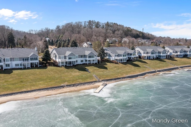 drone / aerial view with a residential view and a water view