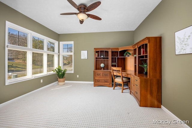 carpeted office featuring ceiling fan, lofted ceiling, and baseboards