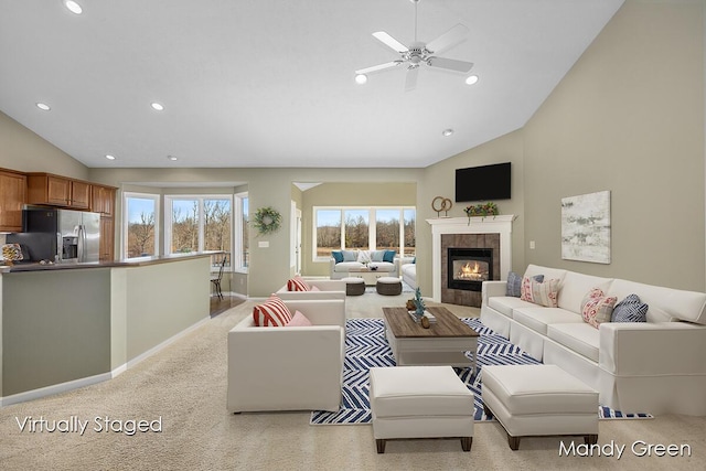 living room featuring recessed lighting, baseboards, plenty of natural light, and a tile fireplace