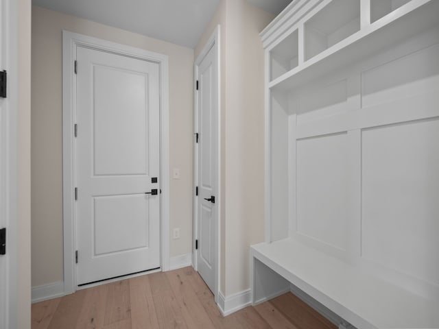 mudroom with baseboards and light wood-style flooring