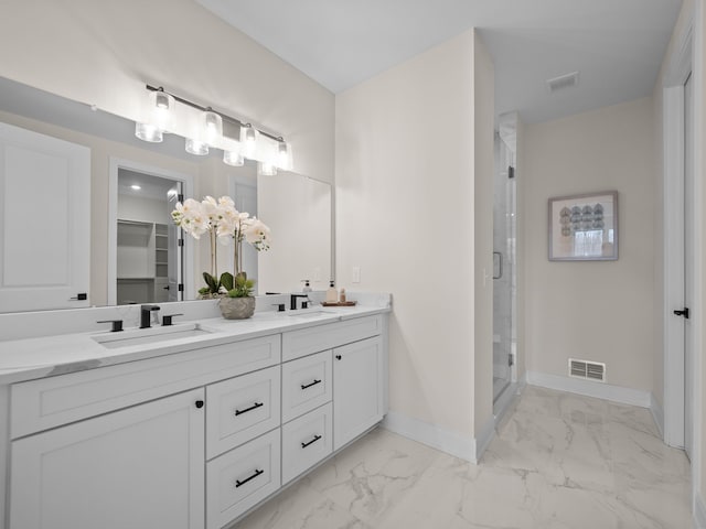 bathroom with baseboards, visible vents, a stall shower, a sink, and marble finish floor