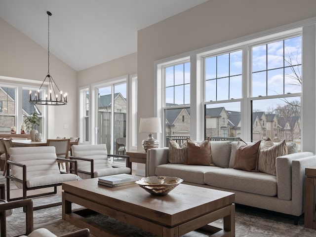 living area featuring high vaulted ceiling and an inviting chandelier