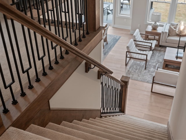 stairway featuring baseboards and wood finished floors