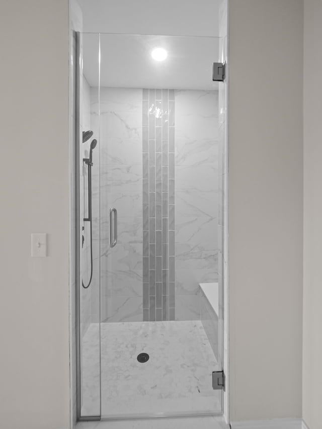 bathroom with a marble finish shower