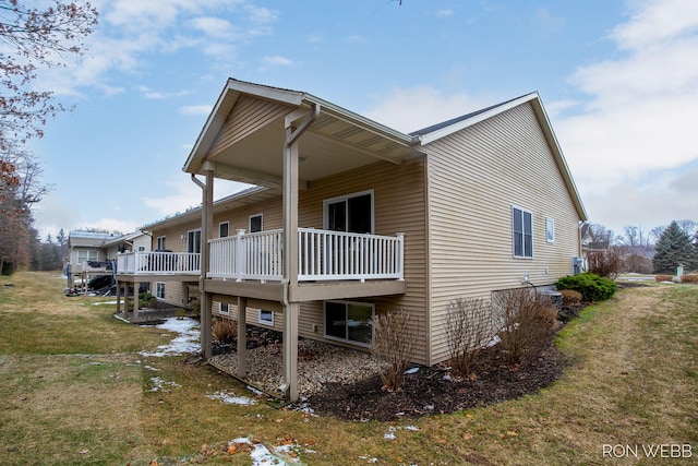 view of home's exterior with a yard and a deck