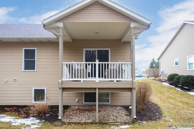 rear view of property featuring a balcony