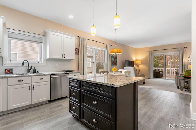 kitchen featuring dark cabinetry, white cabinetry, a sink, hanging light fixtures, and dishwasher