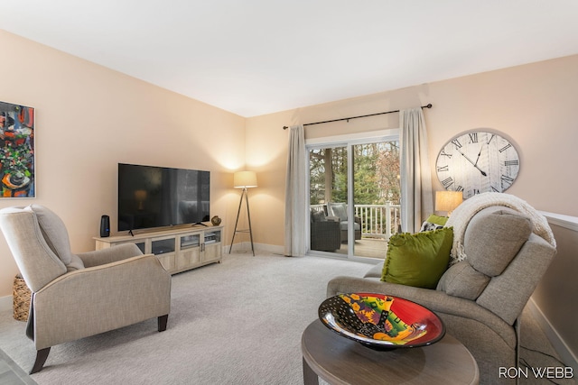 living area with baseboards and carpet floors