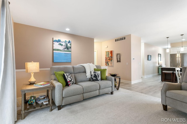 living room with light wood-style flooring, recessed lighting, baseboards, and visible vents