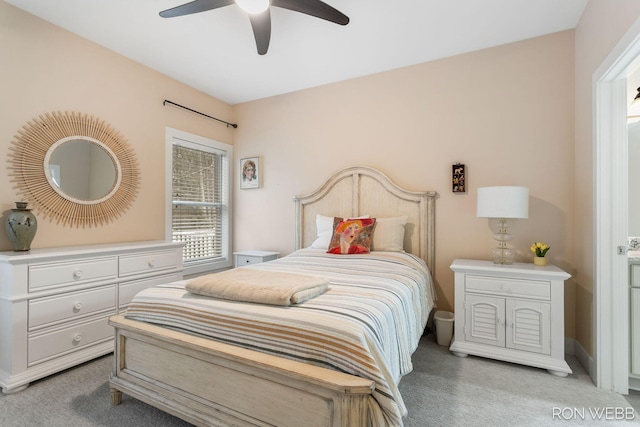 bedroom with a ceiling fan and light carpet