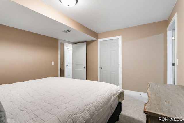 carpeted bedroom featuring visible vents and baseboards