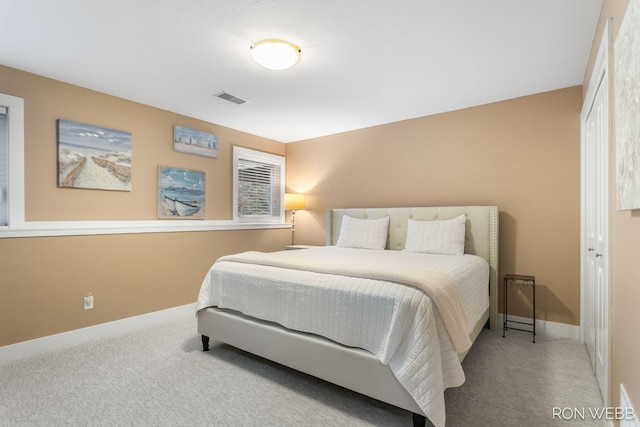 bedroom with visible vents, baseboards, a closet, and carpet flooring