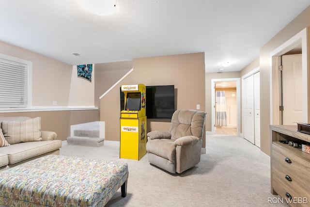 living area with stairs, carpet flooring, and baseboards