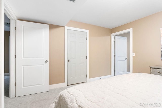 carpeted bedroom featuring baseboards