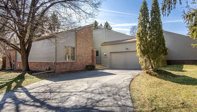 view of home's exterior with a lawn, driveway, and an attached garage